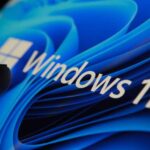 3267144-0-76962700-1792678587-Finger-touching-Windows-11-logo-on-screen-in-dark-room.jpg