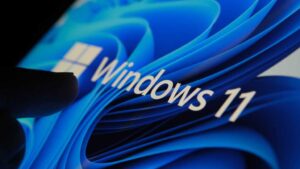 3267144-0-76962700-1792678587-Finger-touching-Windows-11-logo-on-screen-in-dark-room.jpg